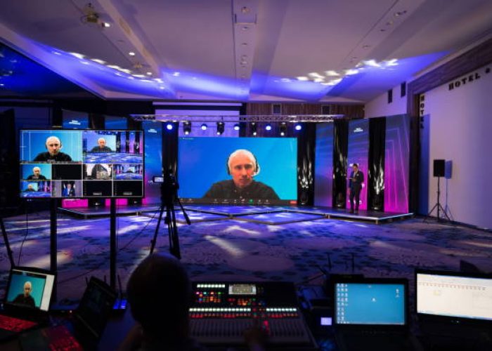 Live internet streaming of business conference meeting, presenter joining a seminar via video conference call in empty convention center. Online webinar or seminar via social network broadcast in new normal, covid outbreak,e-learning.
